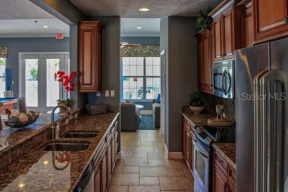 a kitchen with a stove a sink and a refrigerator