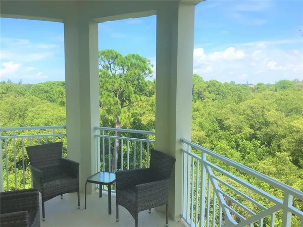 a view of a chair and table in the balcony