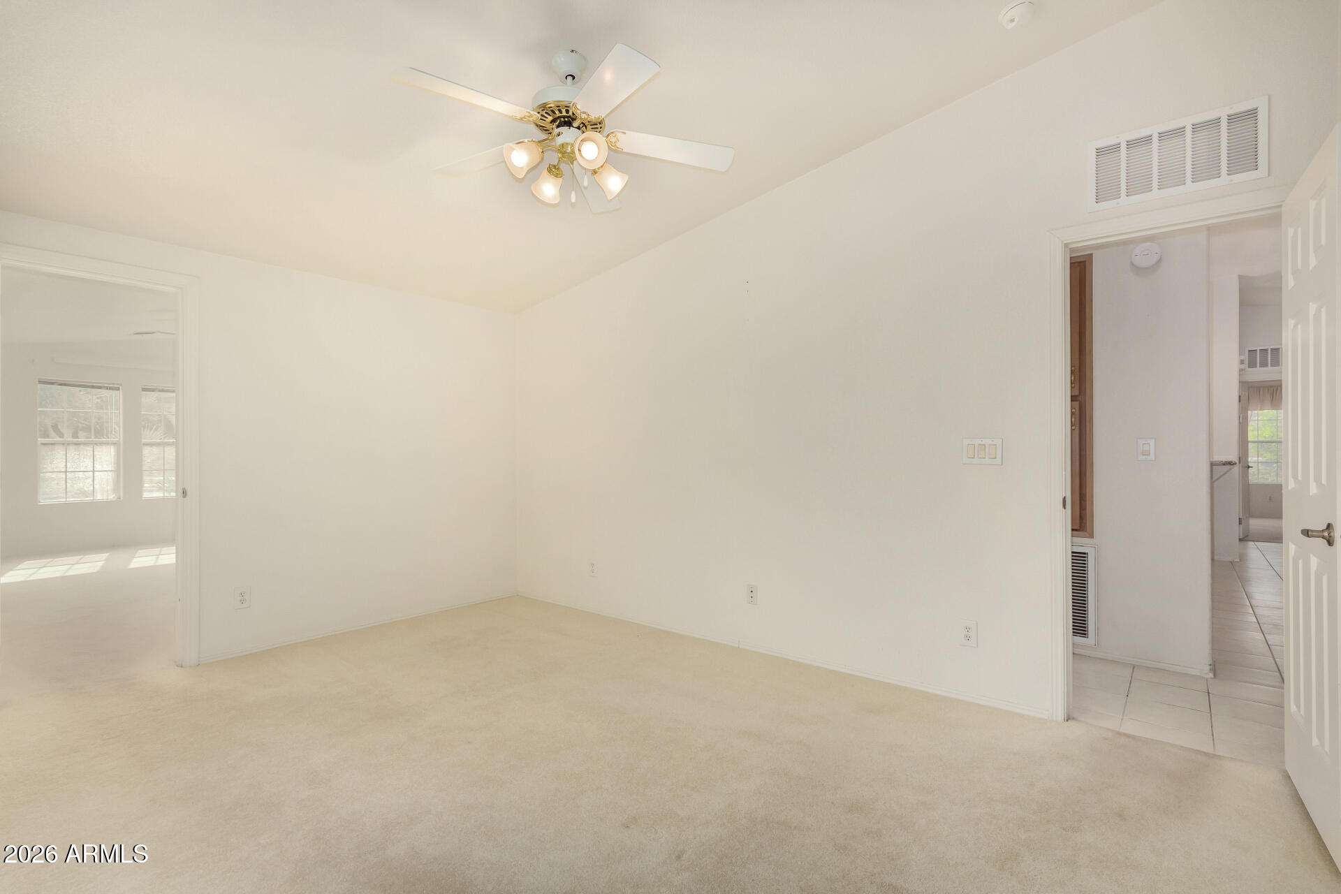 3301 South Goldfield Road, Unit 3004 Apache Junction, AZ 85119 - Photo 24 of 67 an empty room with a chandelier fan and windows