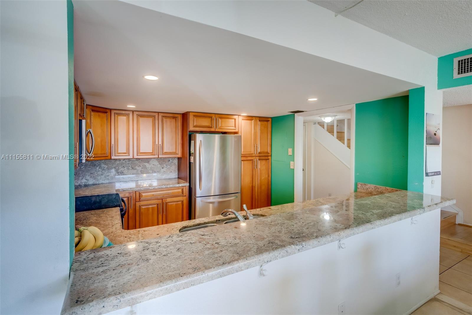 4106 Inverrary Drive, Unit 13C Lauderhill, FL 33319 - Photo 11 of 46 a kitchen with stainless steel appliances granite countertop sink and cabinets