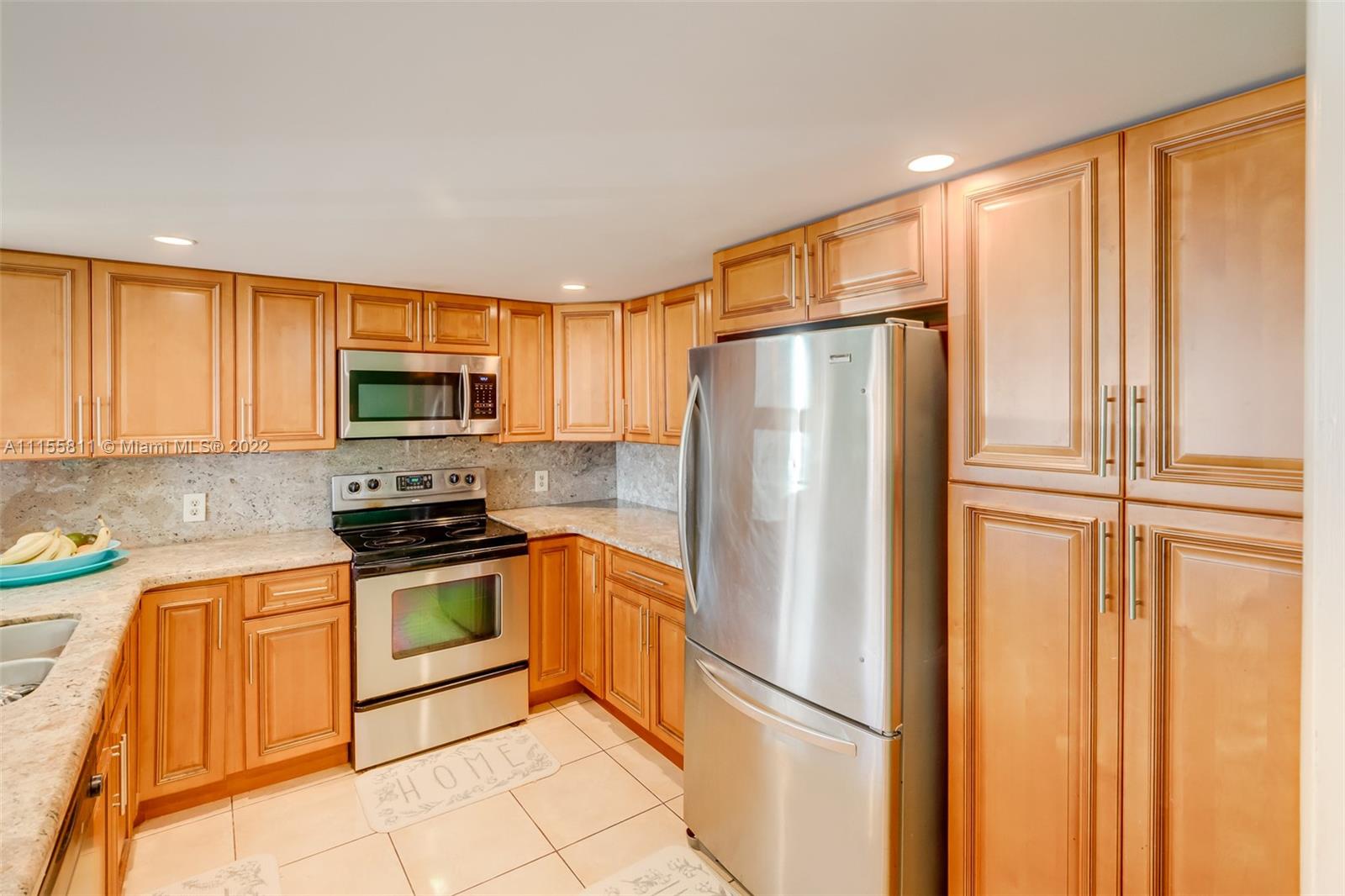 4106 Inverrary Drive, Unit 13C Lauderhill, FL 33319 - Photo 14 of 46 a kitchen with stainless steel appliances granite countertop a refrigerator stove and sink