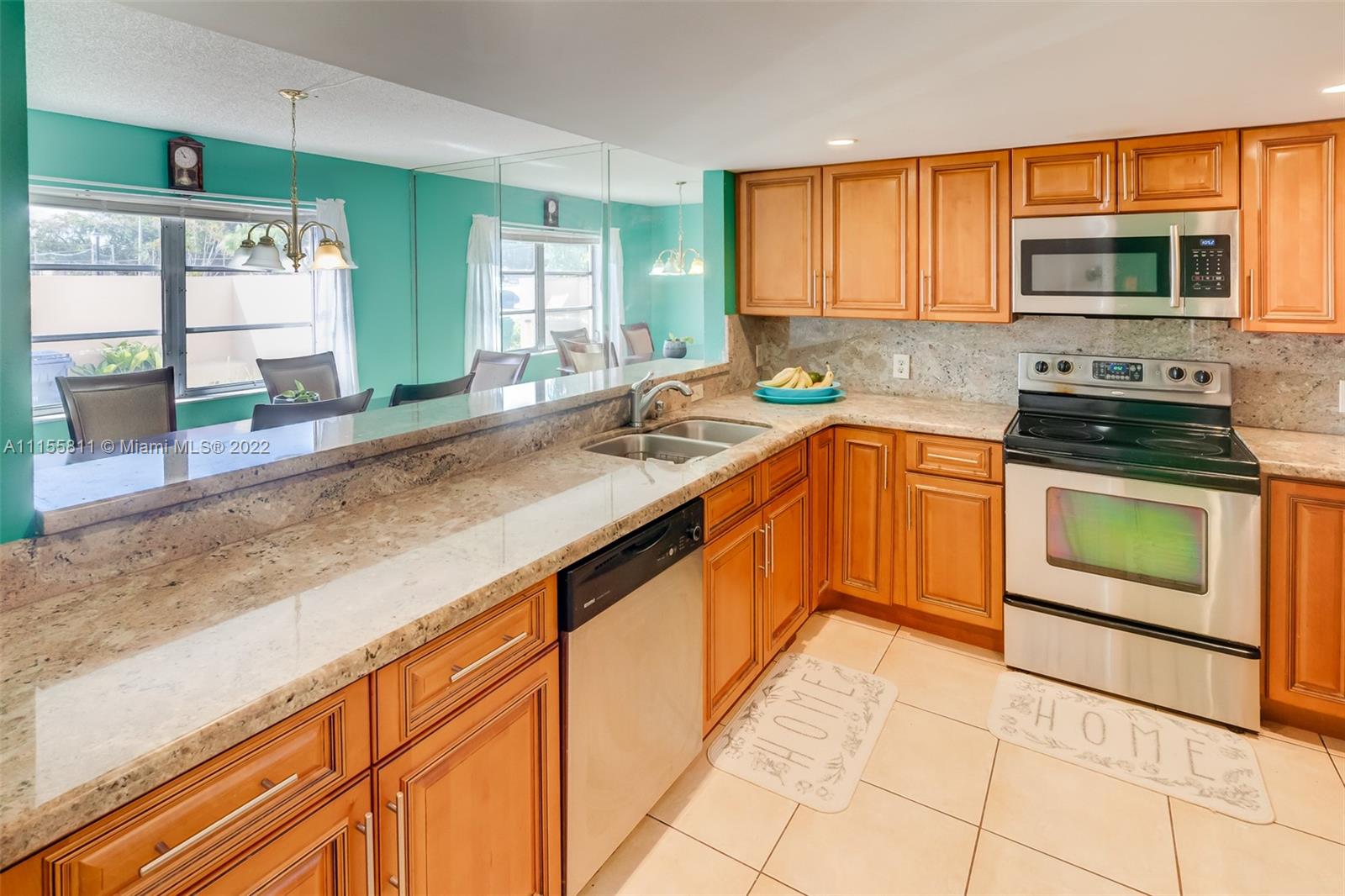 4106 Inverrary Drive, Unit 13C Lauderhill, FL 33319 - Photo 15 of 46 a kitchen with stainless steel appliances granite countertop a sink and a stove