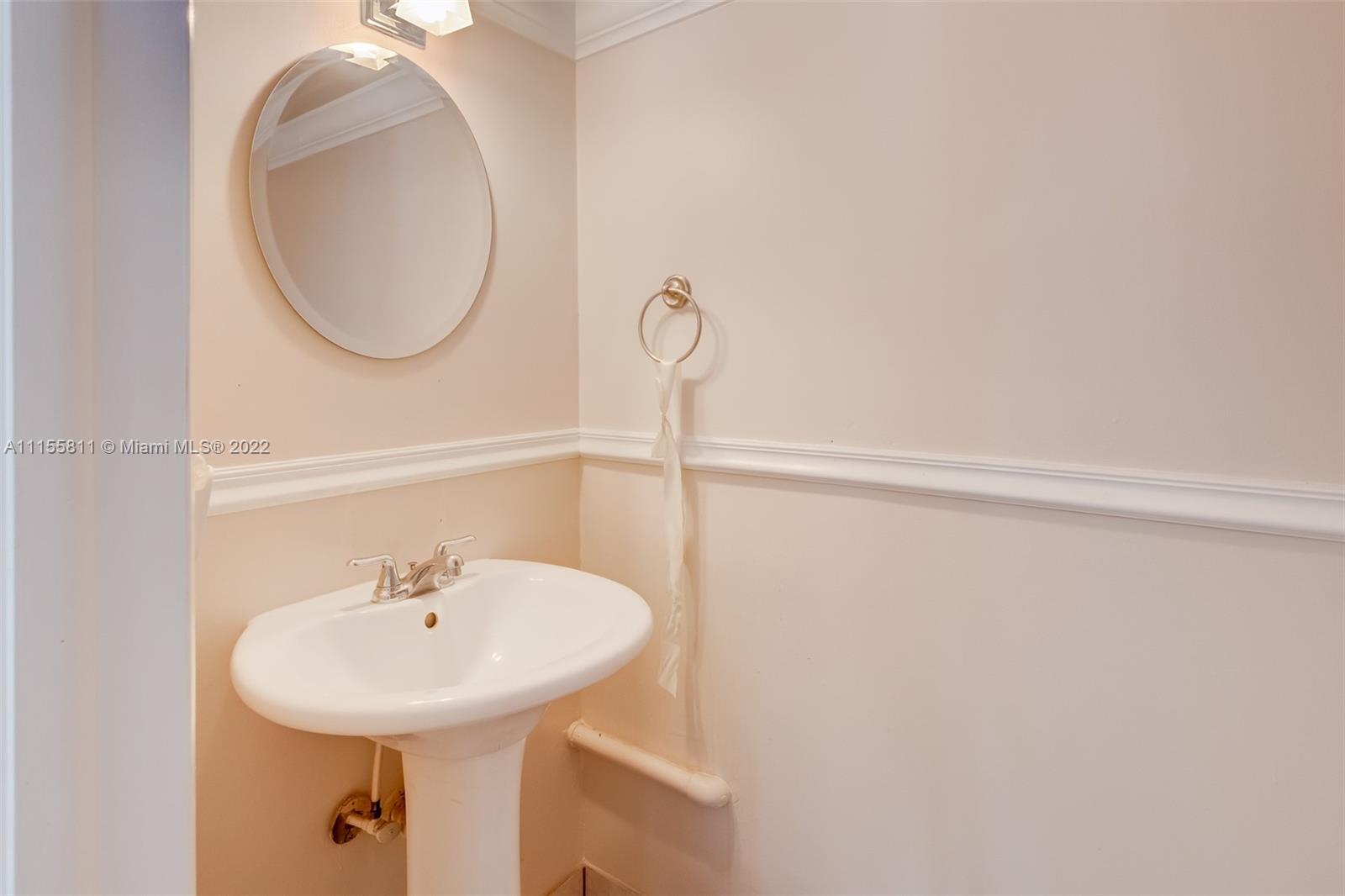 4106 Inverrary Drive, Unit 13C Lauderhill, FL 33319 - Photo 18 of 46 a bathroom with a sink and a mirror