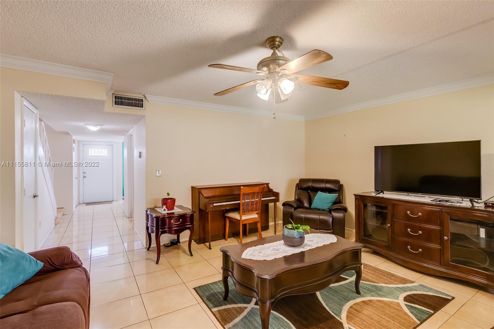 4106 Inverrary Drive, Unit 13C Lauderhill, FL 33319 - Photo 19 of 46 a living room with furniture and a flat screen tv