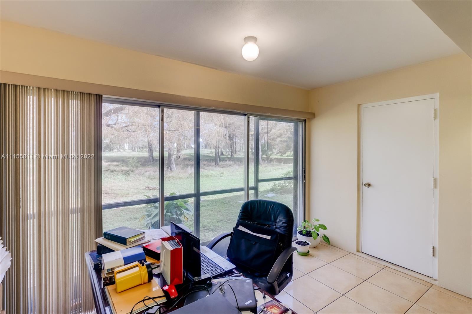4106 Inverrary Drive, Unit 13C Lauderhill, FL 33319 - Photo 23 of 46 a living room with furniture and floor to ceiling windows