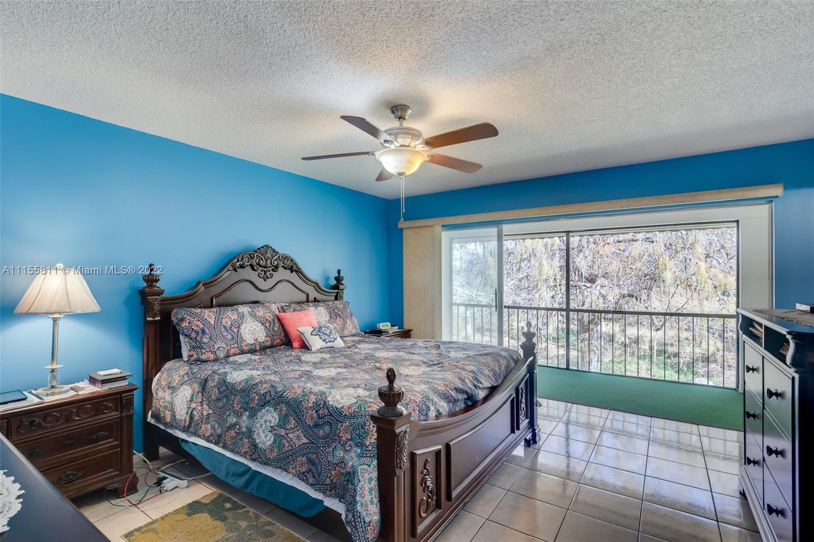 4106 Inverrary Drive, Unit 13C Lauderhill, FL 33319 - Photo 29 of 46 a bedroom with a bed and a large window