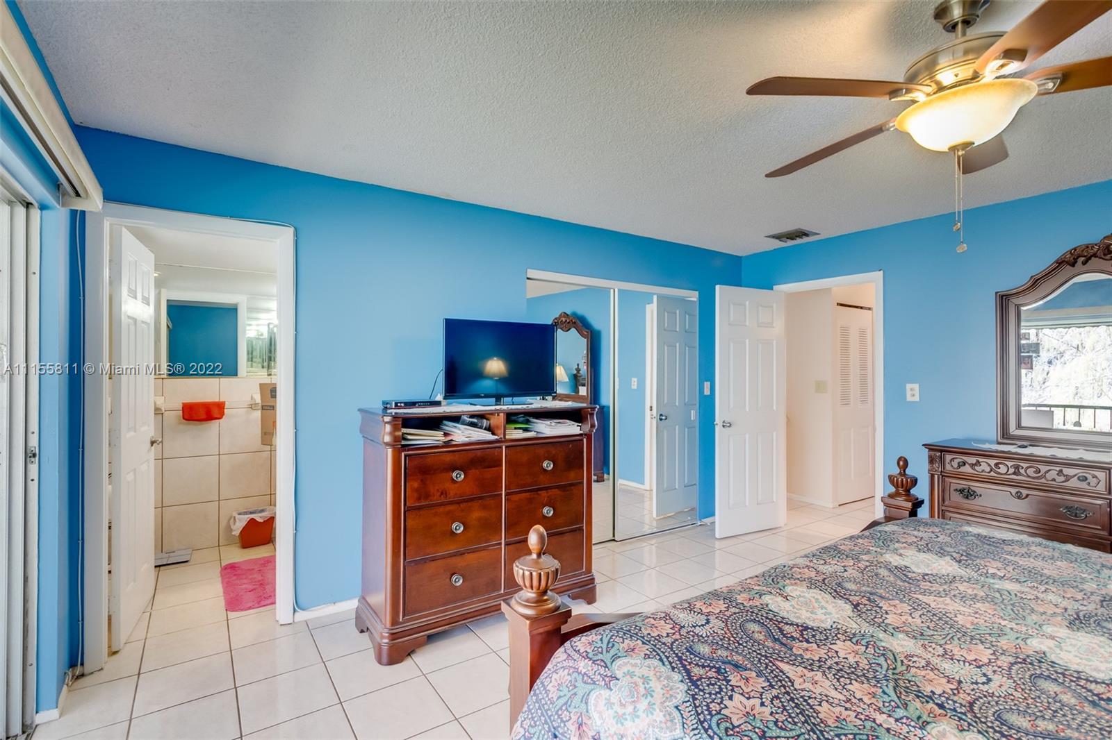 4106 Inverrary Drive, Unit 13C Lauderhill, FL 33319 - Photo 30 of 46 a bedroom with a bed and flat screen tv