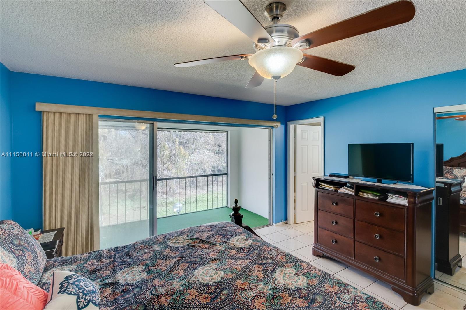 4106 Inverrary Drive, Unit 13C Lauderhill, FL 33319 - Photo 31 of 46 a bedroom with a bed and a flat screen tv