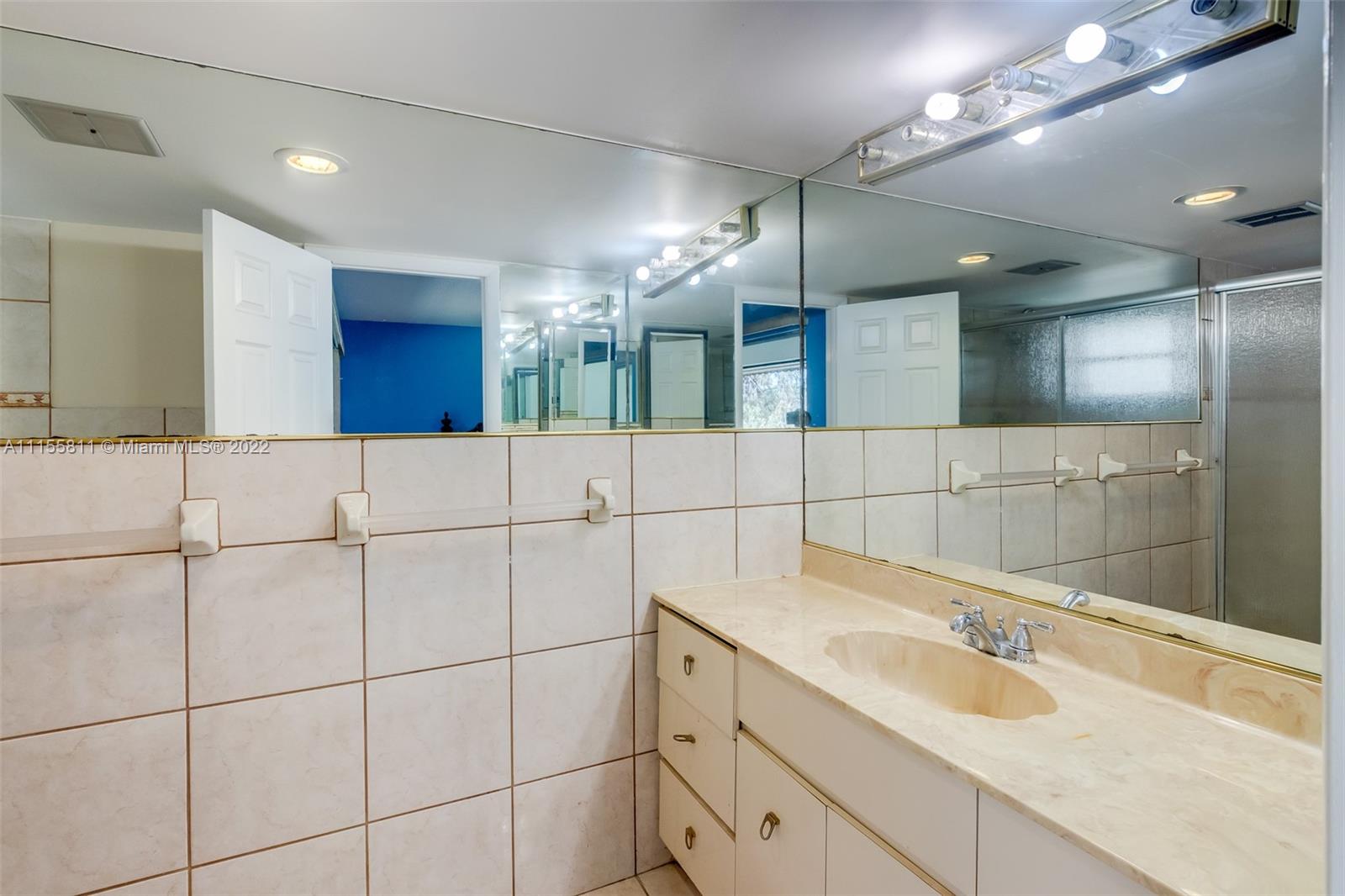 4106 Inverrary Drive, Unit 13C Lauderhill, FL 33319 - Photo 34 of 46 a bathroom with a sink and a mirror