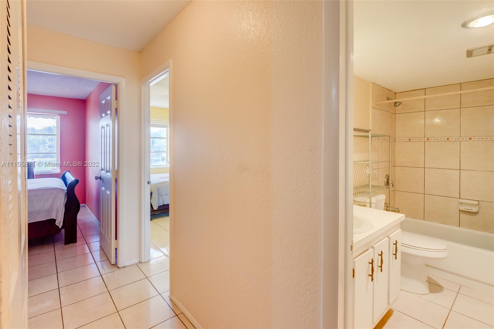 4106 Inverrary Drive, Unit 13C Lauderhill, FL 33319 - Photo 36 of 46 a bathroom with a bathtub and a shower