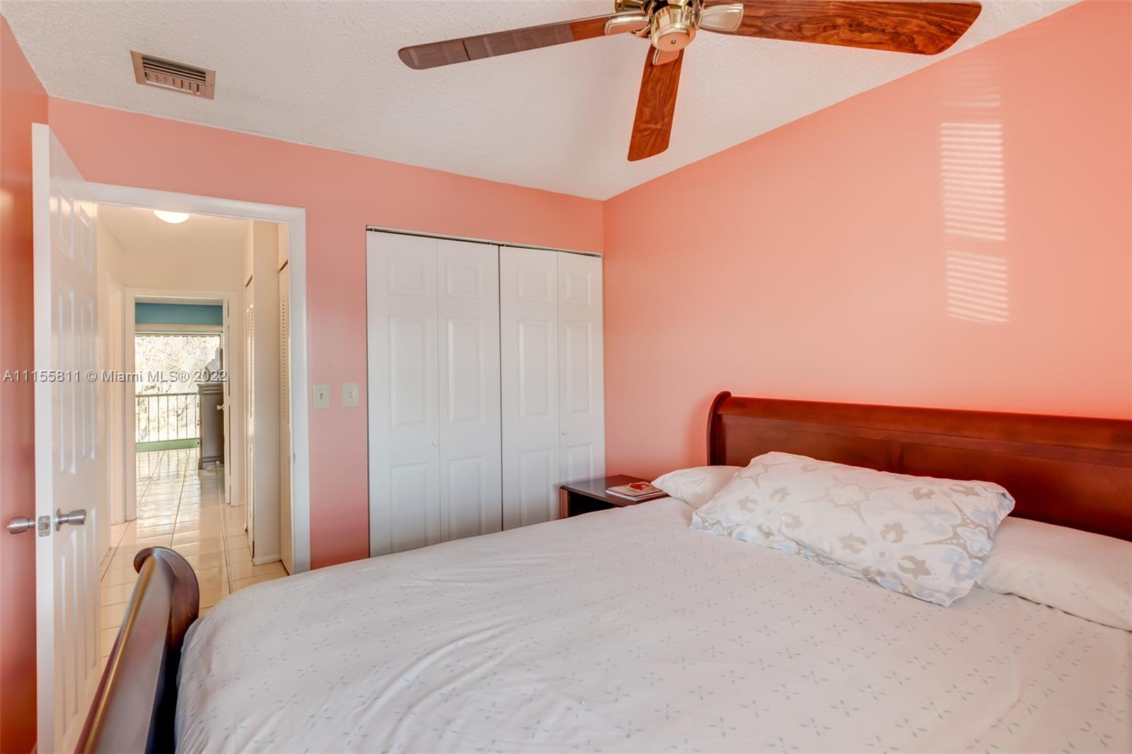 4106 Inverrary Drive, Unit 13C Lauderhill, FL 33319 - Photo 38 of 46 a bedroom with a bed and a chandelier