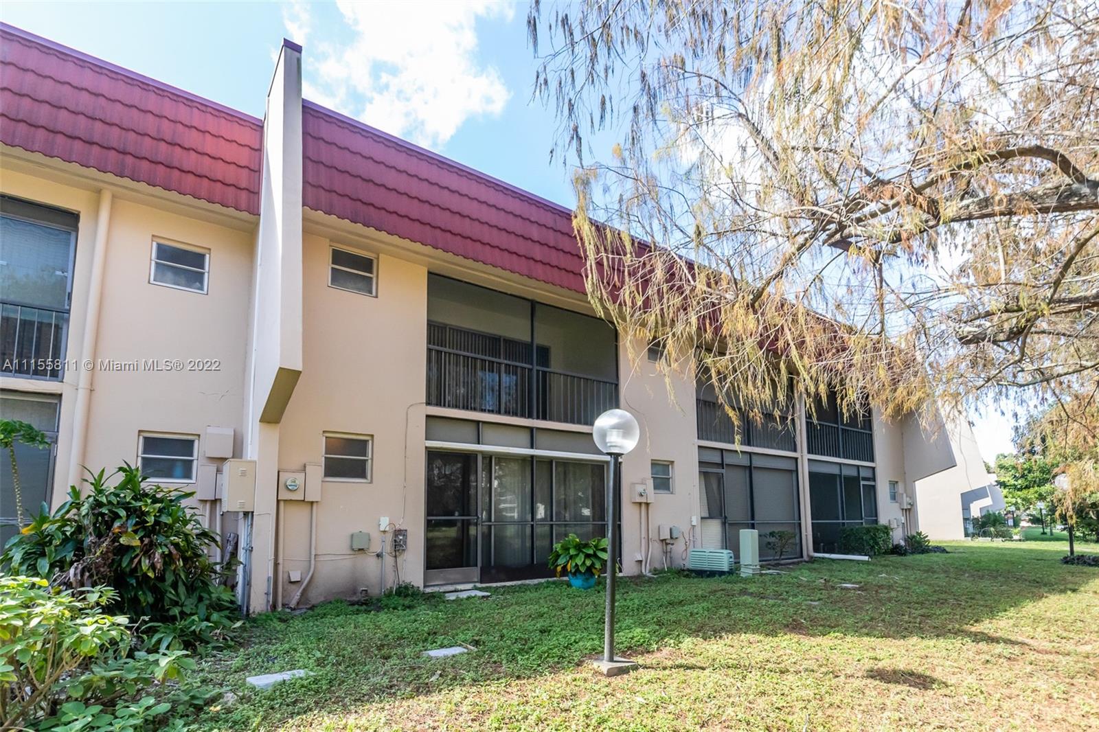 4106 Inverrary Drive, Unit 13C Lauderhill, FL 33319 - Photo 42 of 46 a front view of a house with a yard