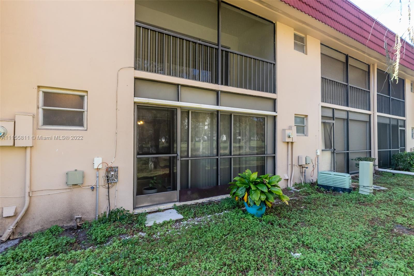 4106 Inverrary Drive, Unit 13C Lauderhill, FL 33319 - Photo 44 of 46 a view of front door and potted plants