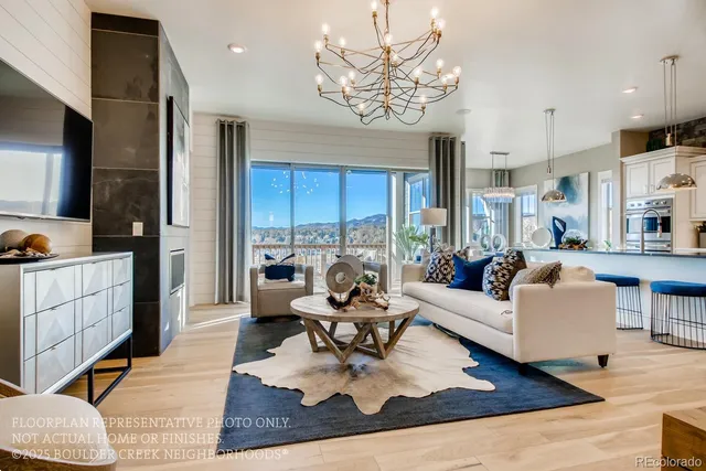 a living room with furniture or chandelier and a wooden floor