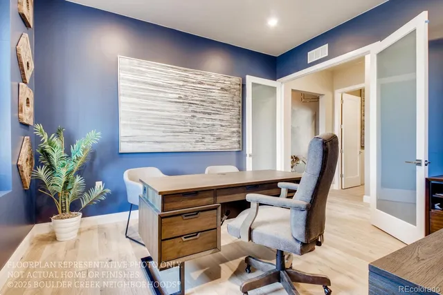 a view of a workspace with furniture and a potted plant