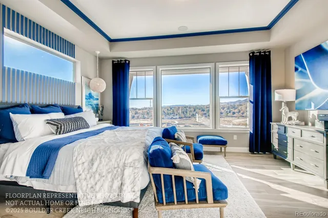 a bedroom with two beds and large windows