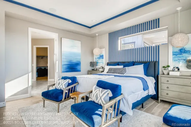 a bedroom with furniture and a large window