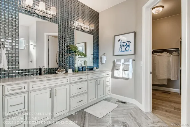 a spacious bathroom with a granite countertop sink and a mirror