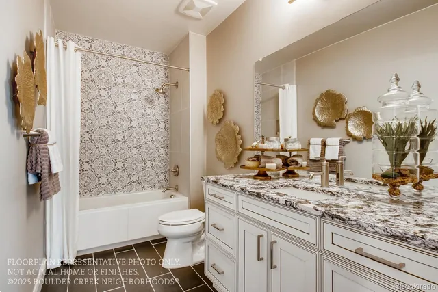 a bathroom with a granite countertop sink mirror vanity and toilet