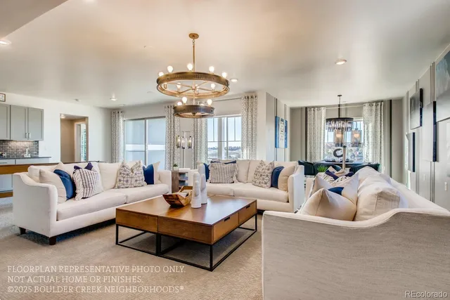 a living room with furniture a chandelier and a chandelier