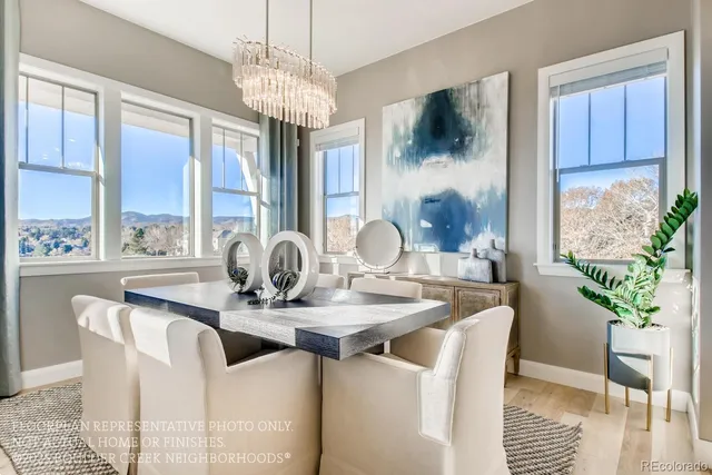 a dining room with furniture potted plants and wooden floor