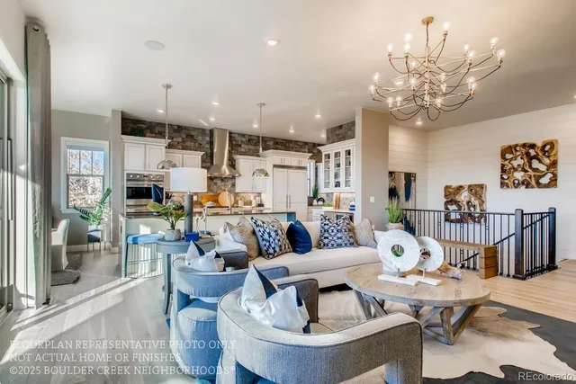 a living room with fireplace furniture and a chandelier