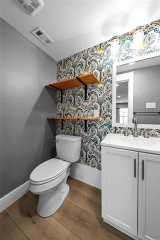 a bathroom with a toilet sink and mirror