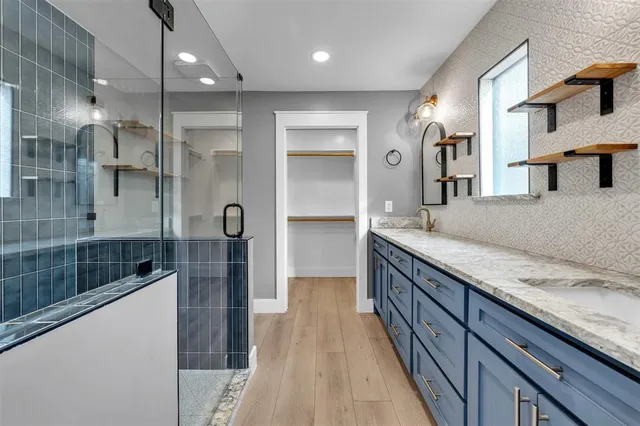 a bathroom with a granite countertop sink