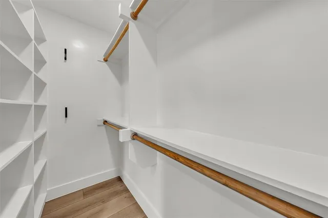 a view of closet with wooden floor