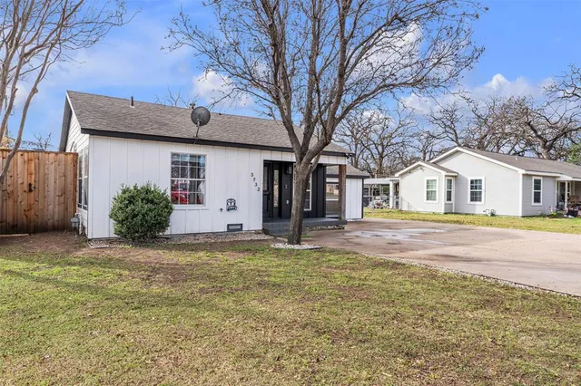 a house that has a large tree in front of it