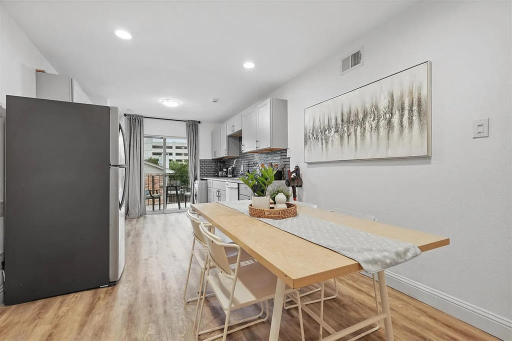 8083 Meadow Road, Unit 265 Dallas, TX 75231 - Photo 20 of 22 Dining area featuring light wood finished floors and baseboards