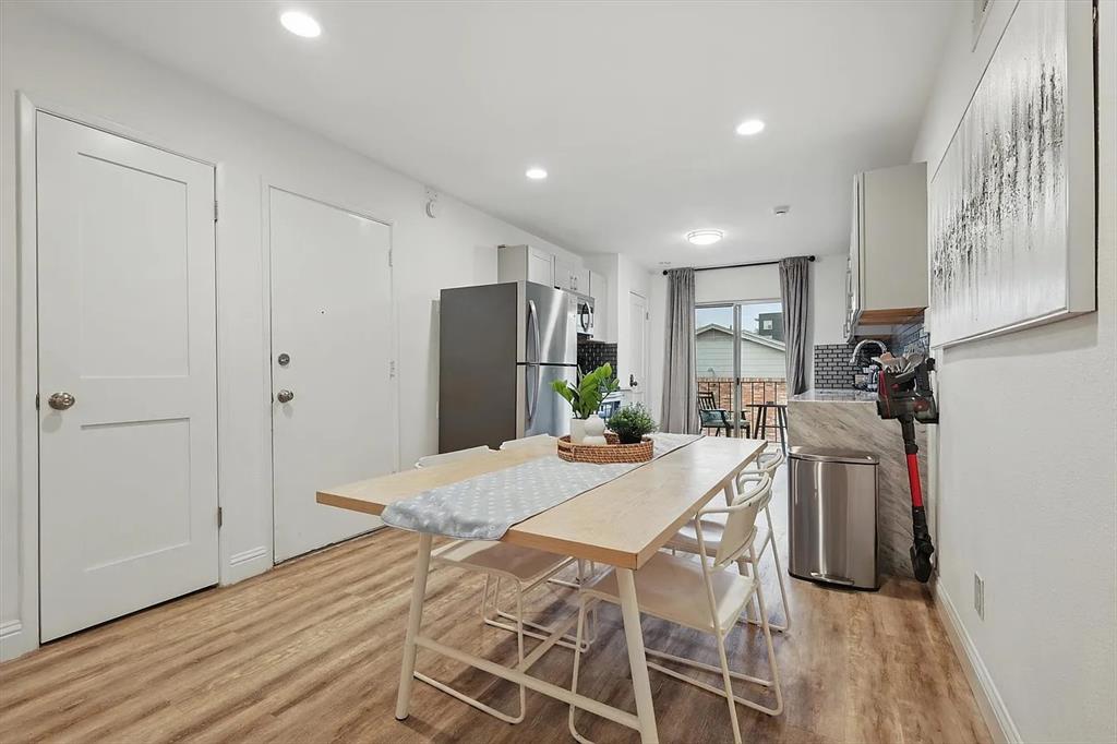 8083 Meadow Road, Unit 265 Dallas, TX 75231 - Photo 6 of 22 Kitchen with freestanding refrigerator, light wood-style floors, recessed lighting, white cabinetry, and light countertops