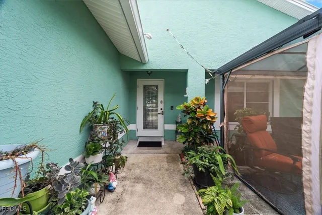 a front view of a house with a flower garden