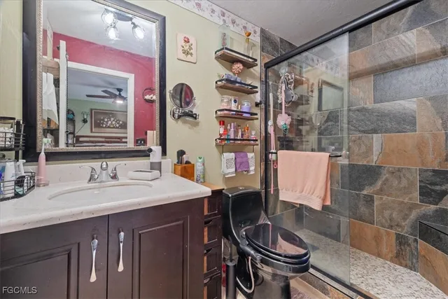 a bathroom with a sink a toilet and shower