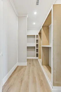 a view of an empty room with a cabinet and a window
