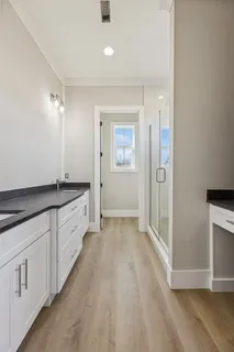 a spacious bathroom with a granite countertop sink and a mirror