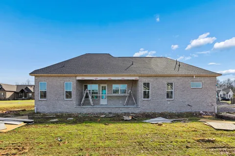 a view of a house with swimming pool and a yard