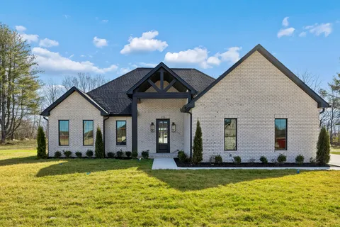 a view of a house with swimming pool and yard