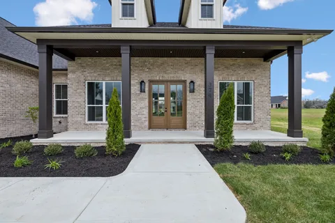 front view of a building with a garden