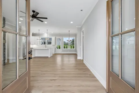 a view of a kitchen with wooden floor and a window