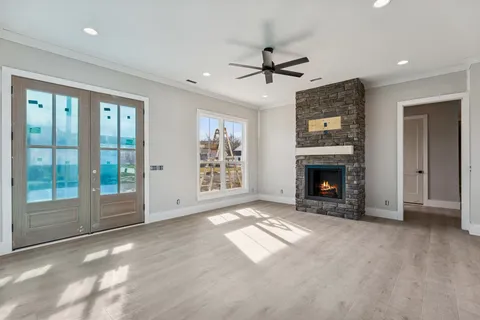 a view of empty room with fireplace and fan