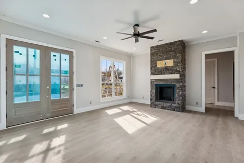 a view of empty room with window and fireplace