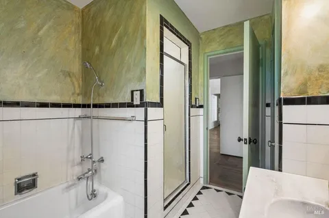 a bathroom with a bathtub and a shower