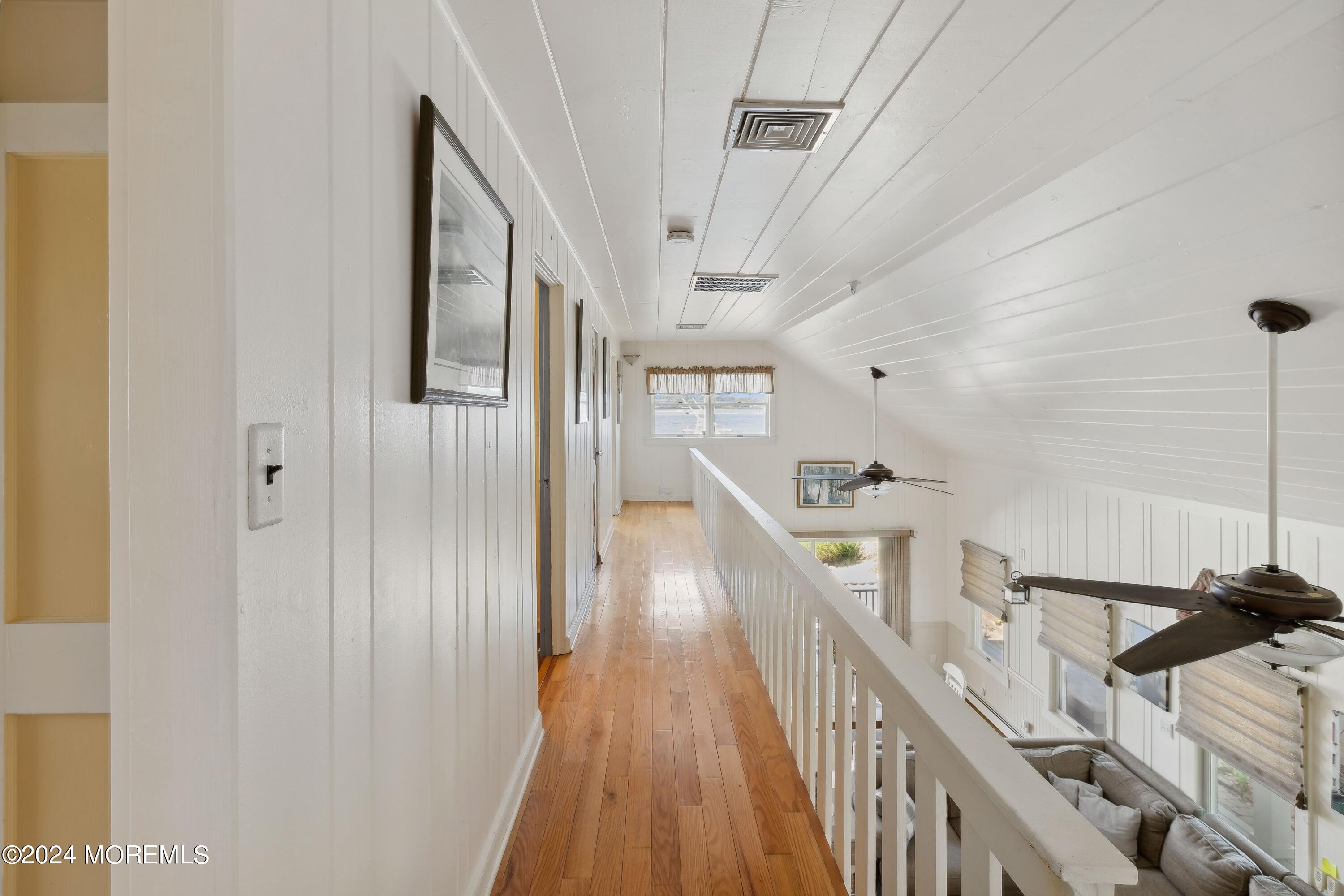 1119 Sampson Road Point Pleasant, NJ 08742 - Photo 12 of 29 a view of a hallway with wooden floor and staircase