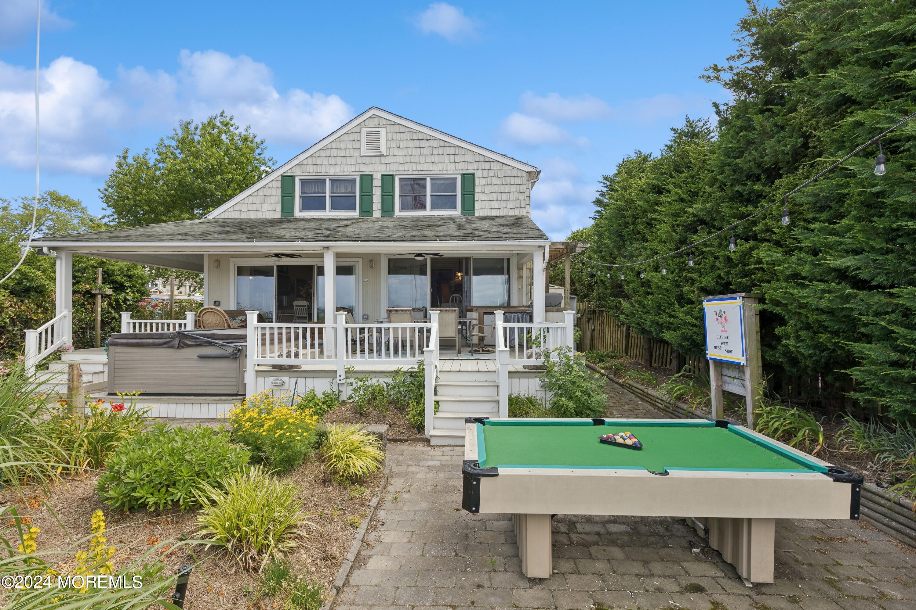 1119 Sampson Road Point Pleasant, NJ 08742 - Photo 24 of 29 a front view of a house with a yard table and chairs