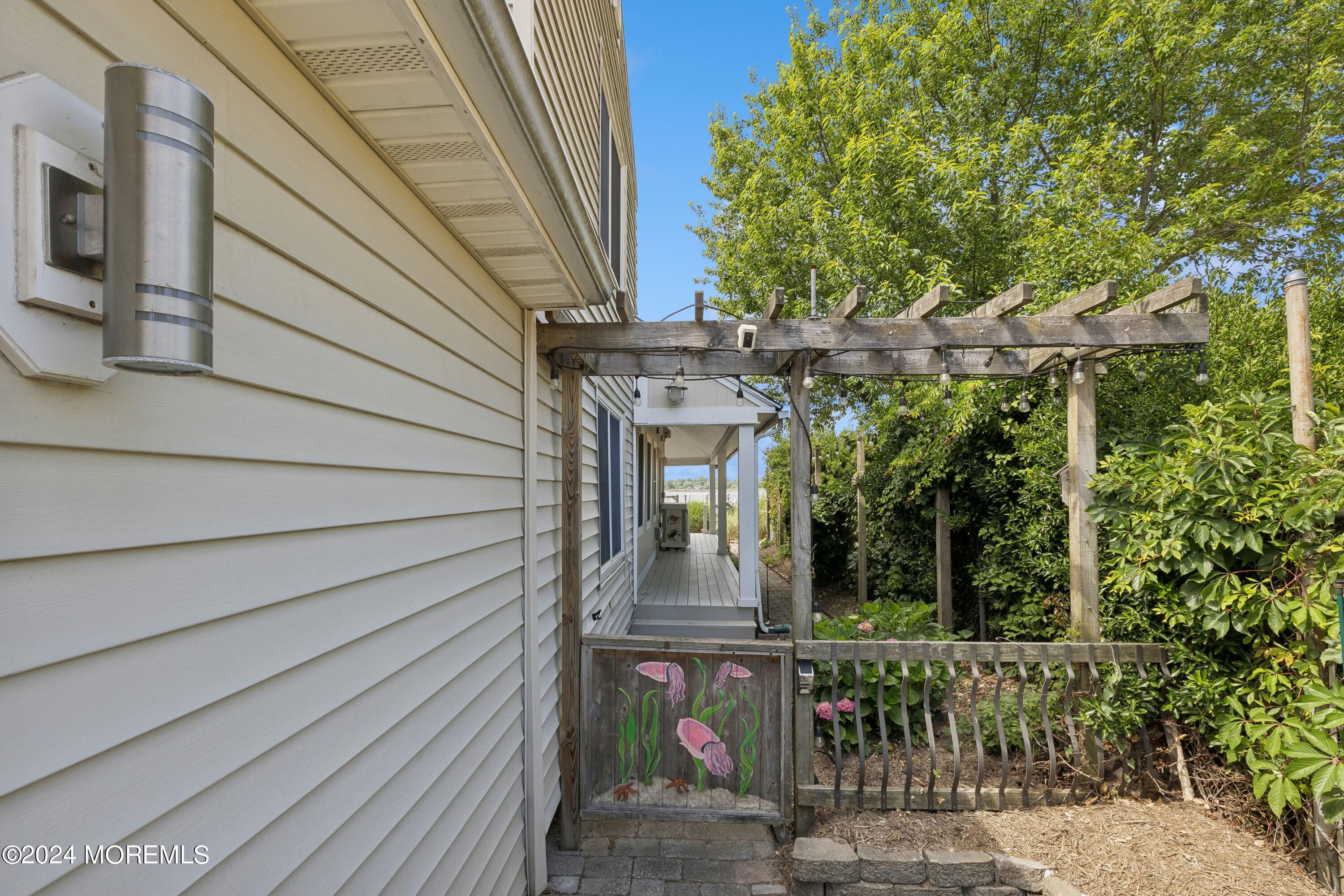 1119 Sampson Road Point Pleasant, NJ 08742 - Photo 25 of 29 a view of a brick house with a tree