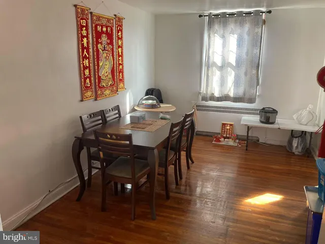 a view of a a dining room with furniture window and wooden floor