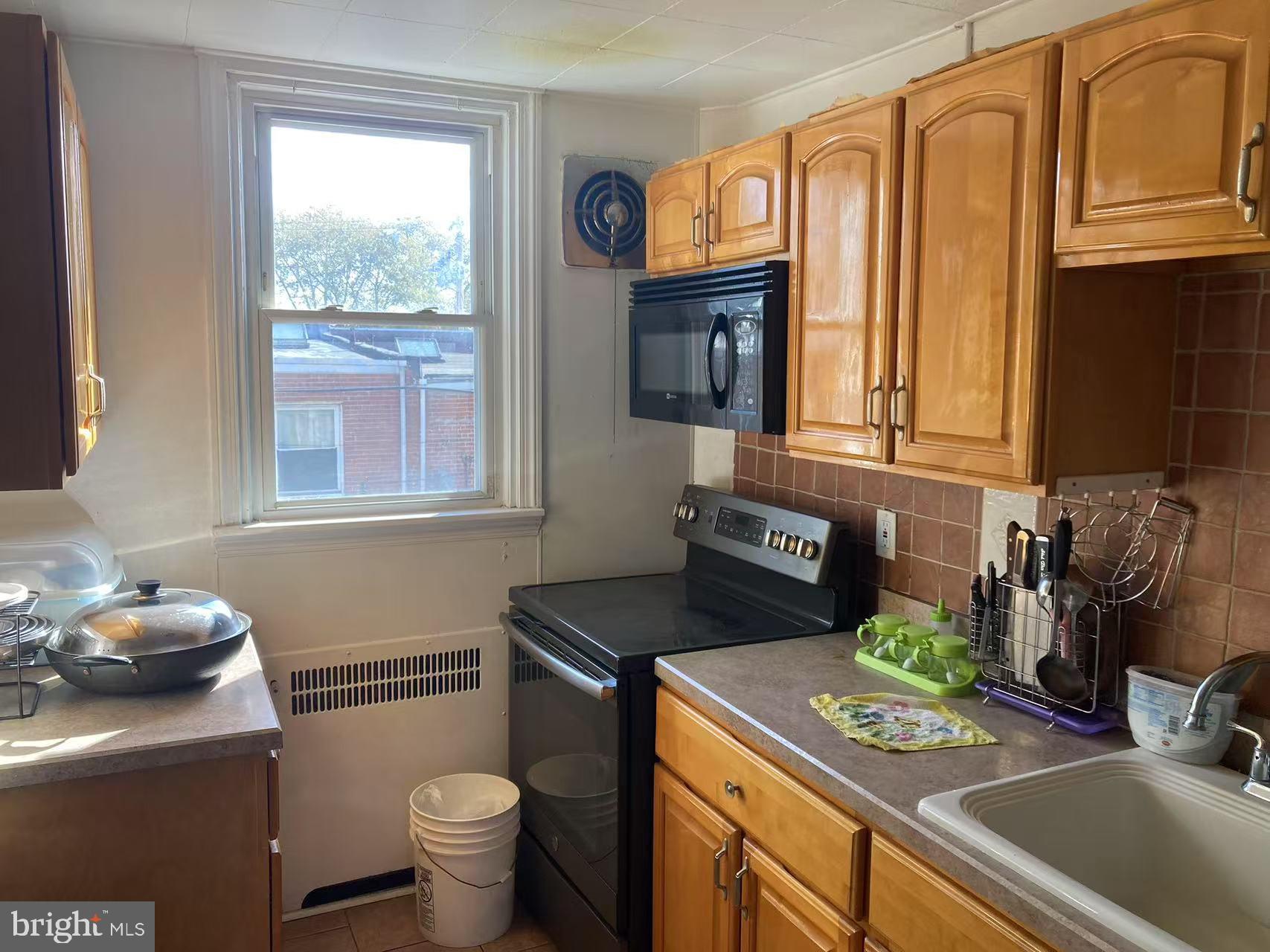 275 Glendale Road Upper Darby, PA 19082 - Photo 5 of 20 a kitchen with a sink cabinets and a stove top oven