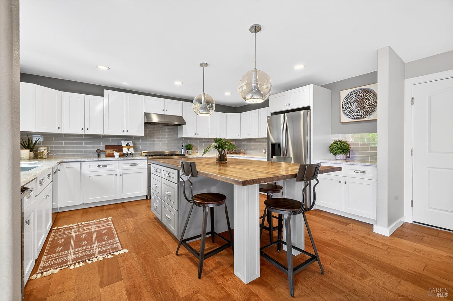 4720 Granada Drive Santa Rosa, CA 95409 - Photo 13 of 68 a kitchen with granite countertop wooden floors and white cabinets