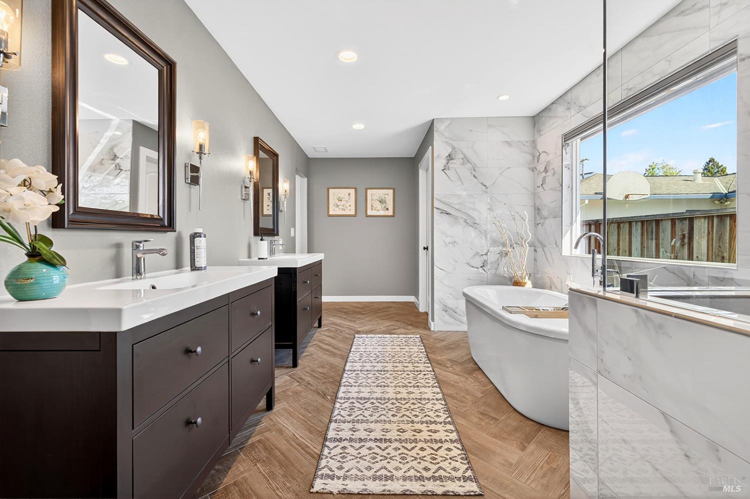 4720 Granada Drive Santa Rosa, CA 95409 - Photo 36 of 68 a large bathroom with a double vanity sink a large mirror and a bathtub